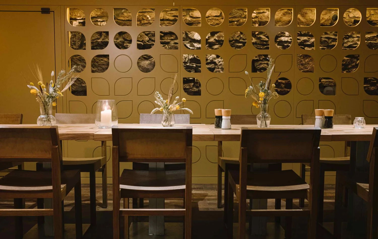 The candlelit downstairs private dining room at Hendersons with its sculptural screen wall